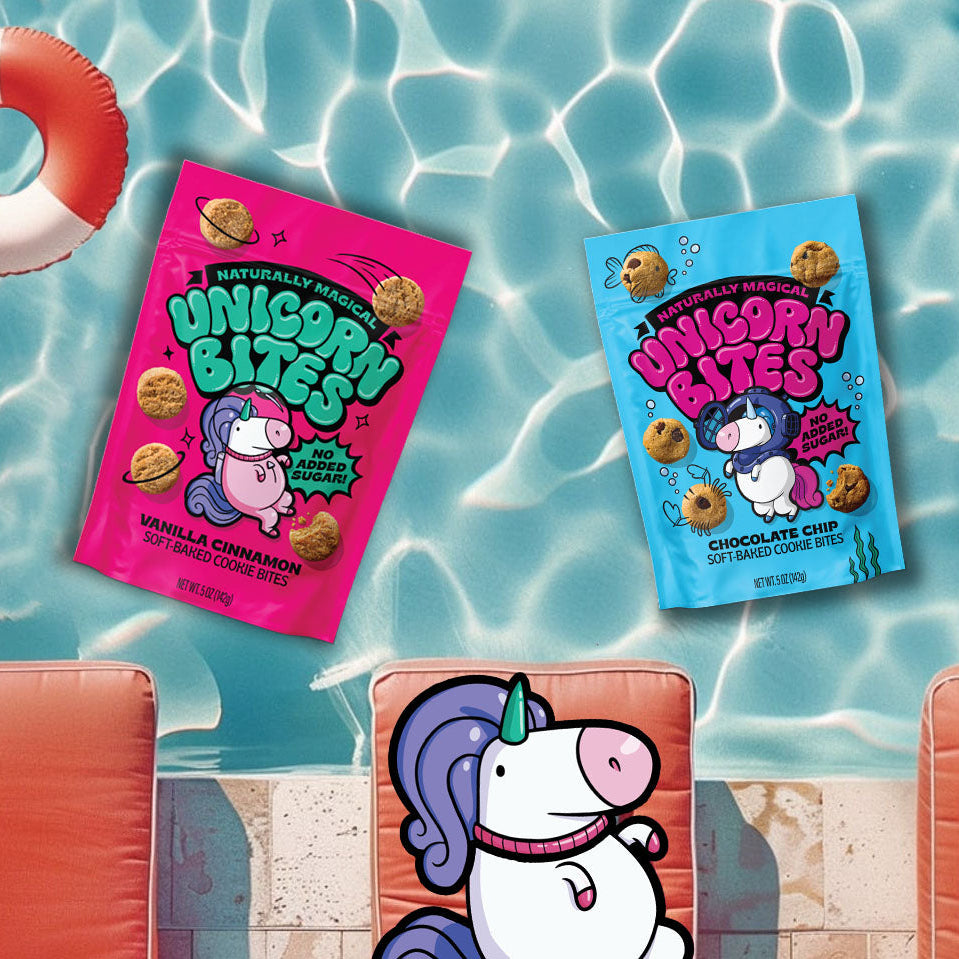 Two packages of Unicorn Bites snacks on a poolside background with inflatable rings and lounge chairs.