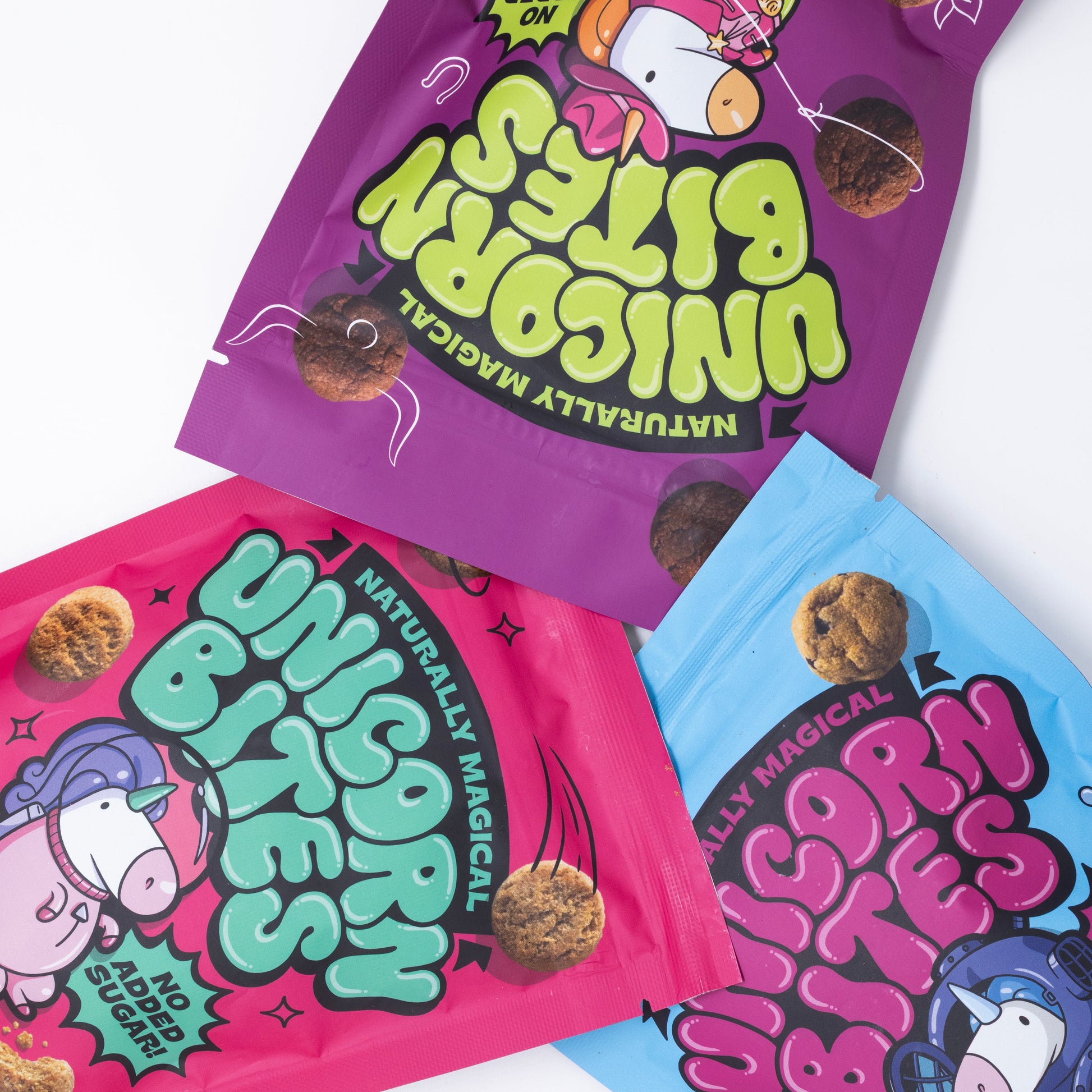 Three colorful packages of 'Unicorn Bites' on a white background