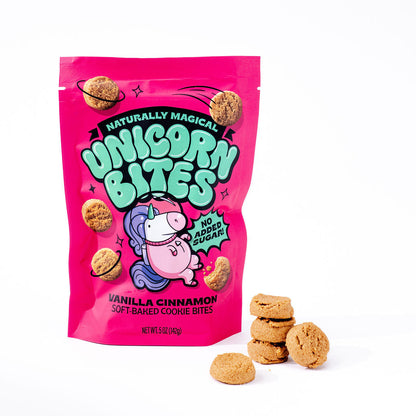 Pink bag of 'Unicorn Bites' vanilla cinnamon soft-baked cookie mix with cookies on a white background